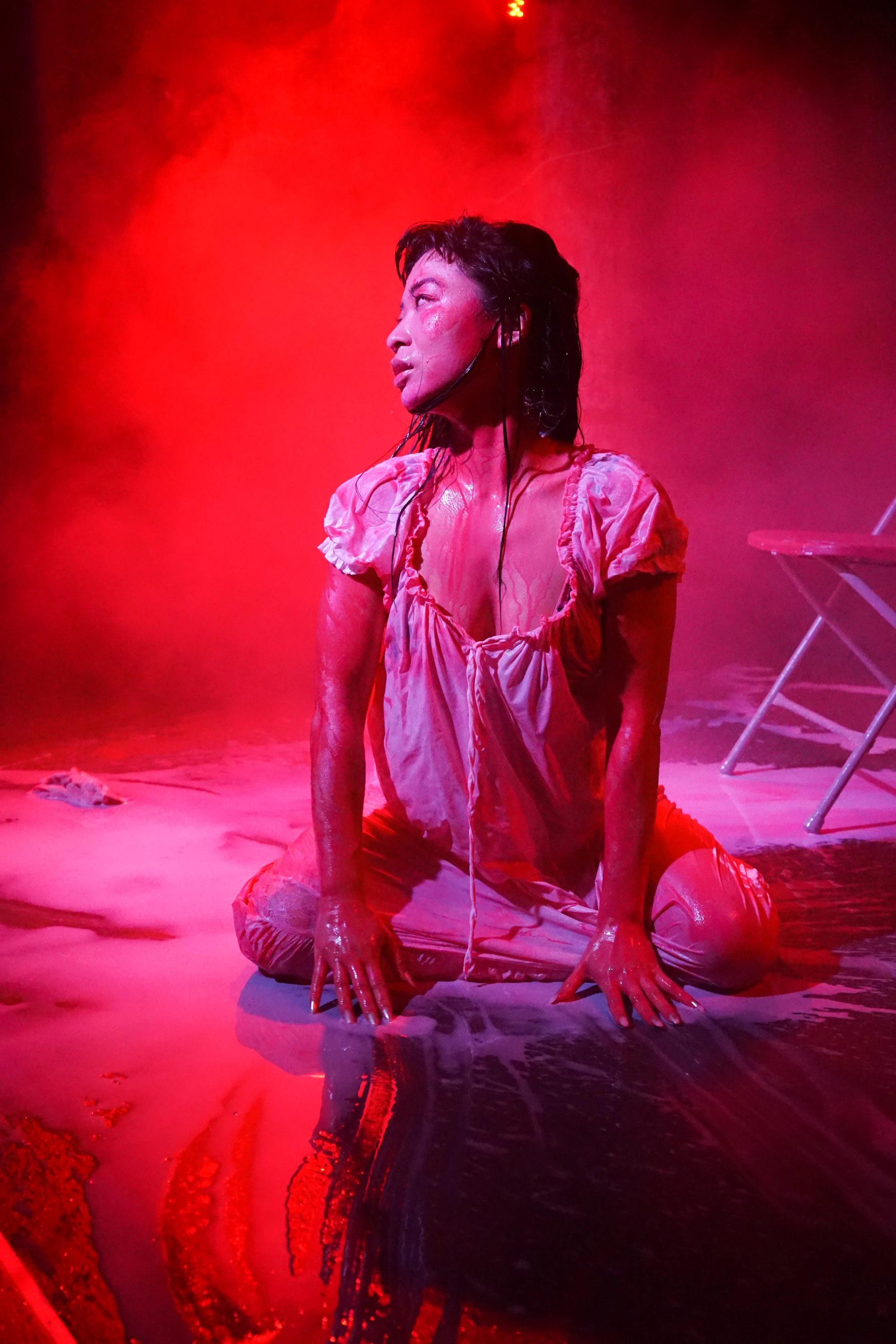 a woman in a white dress is drenched in milk.