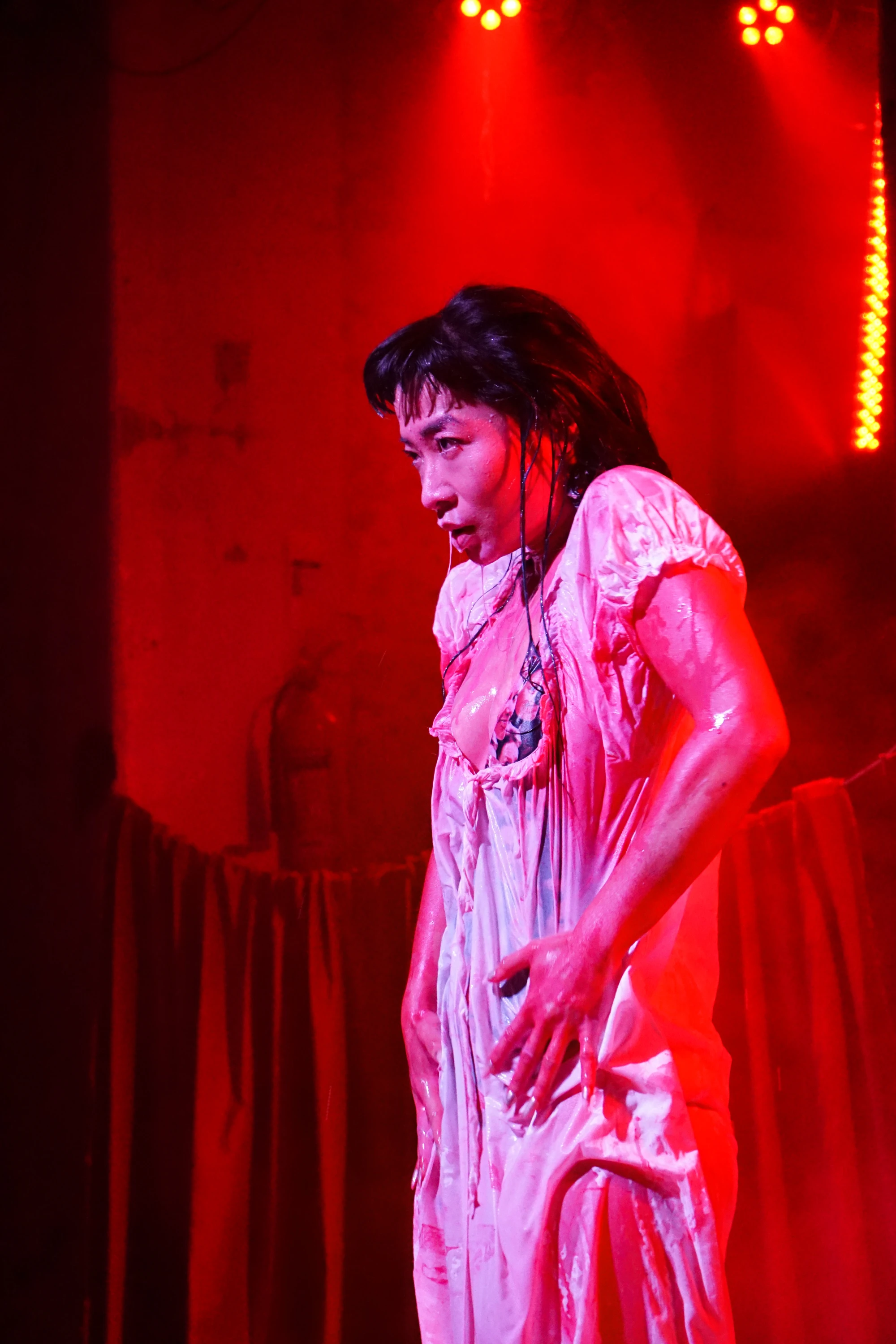 a woman in a white dress is drenched in milk.