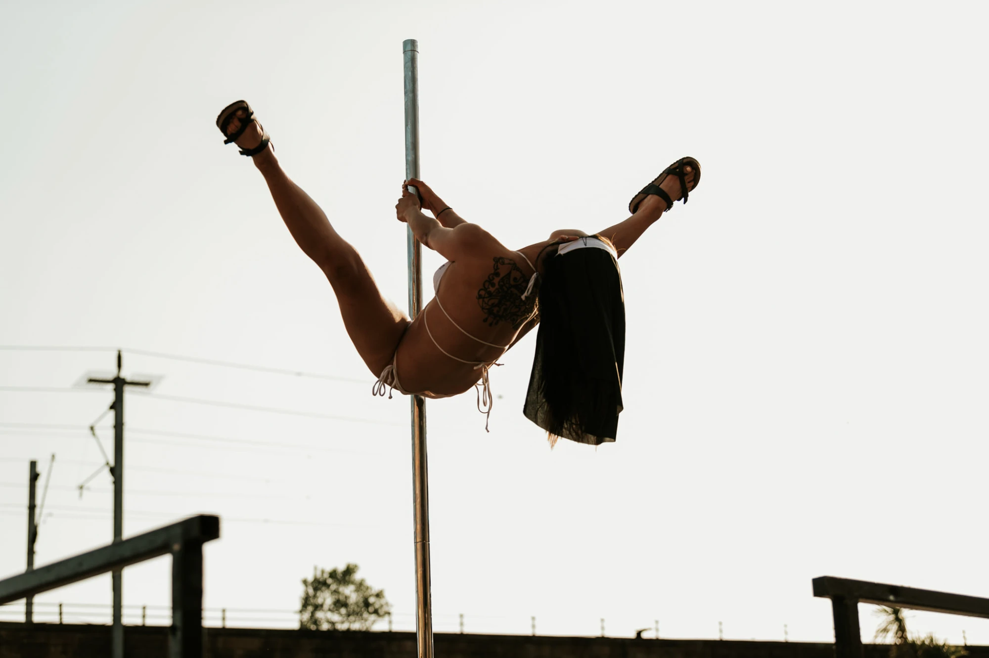 a woman is on the pole wearing a nuns habit.