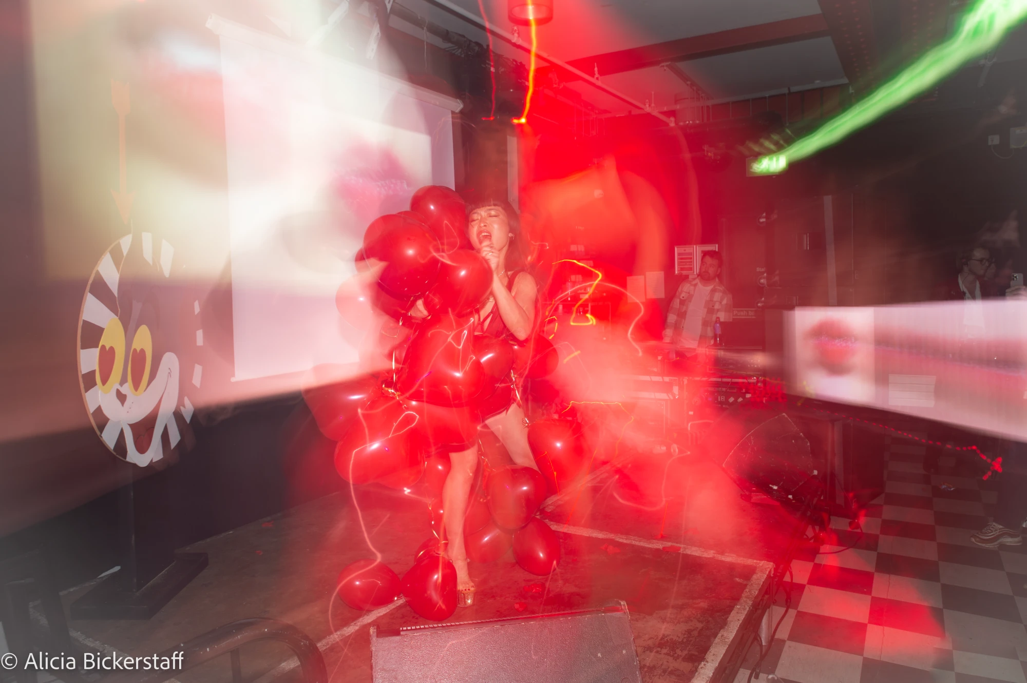 a woman is wearing a dress made out of balloons.