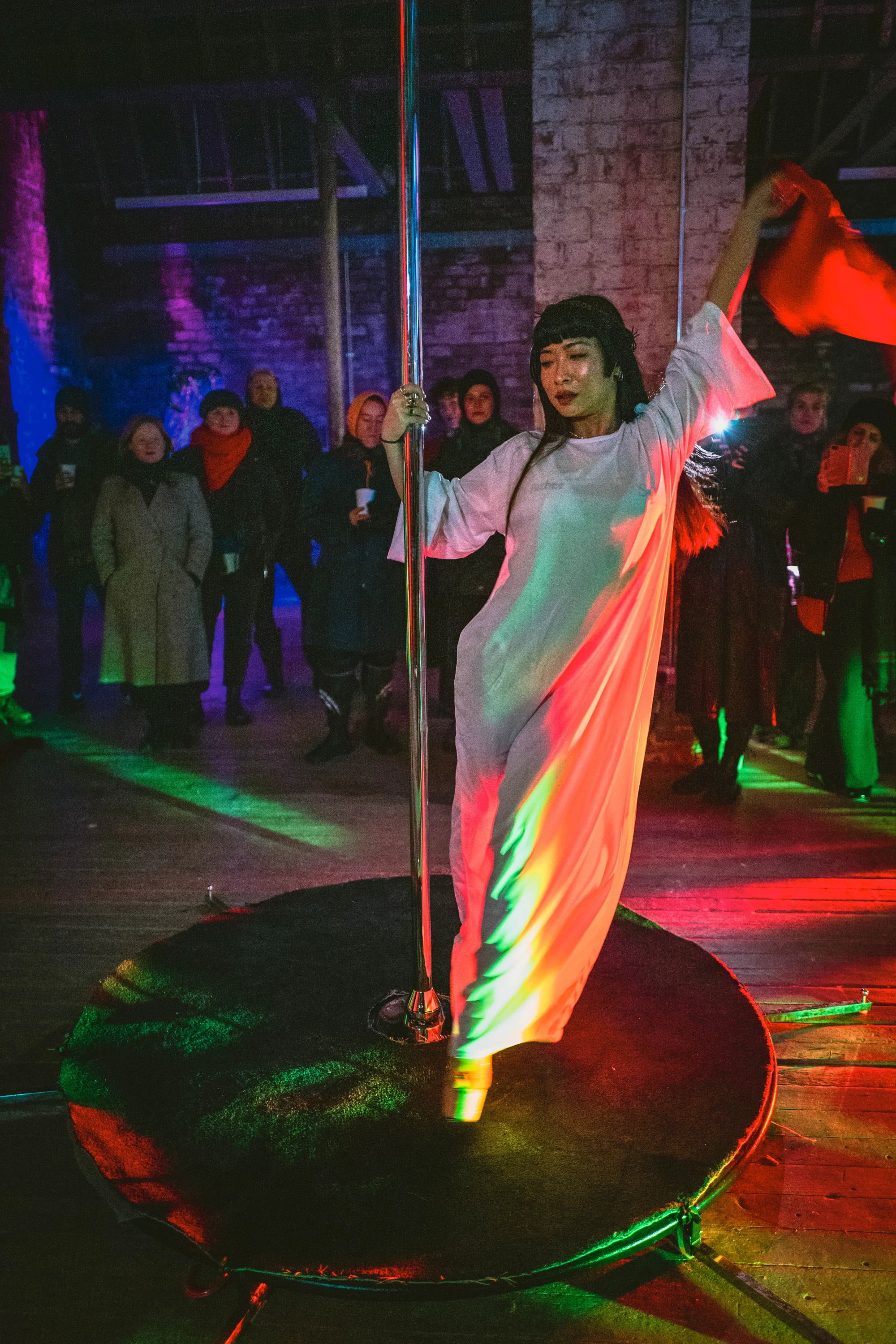 a woman dressed as jesus strips off on the pole.