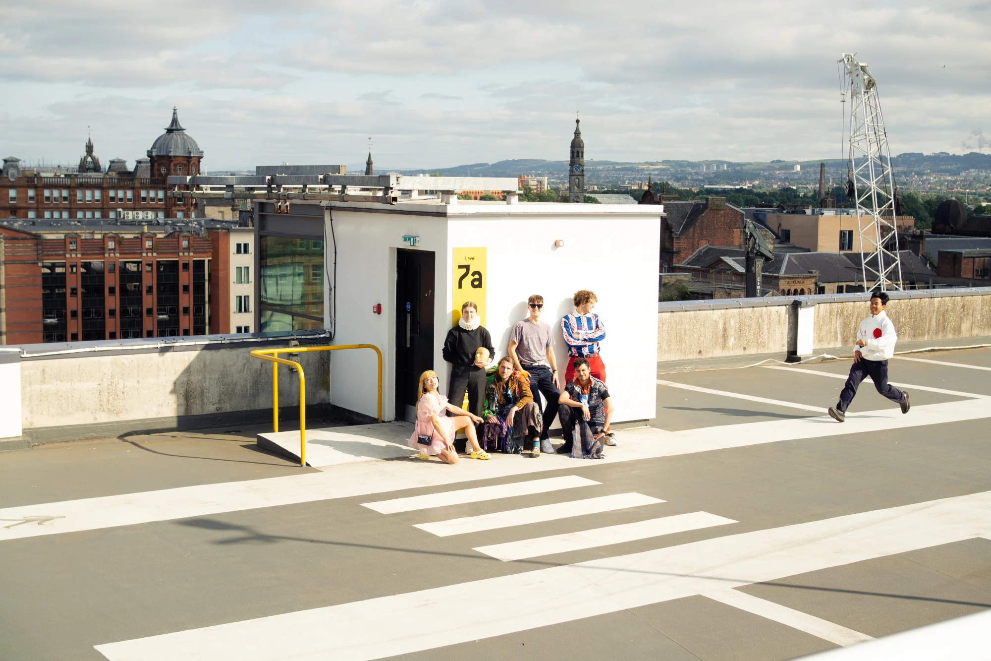 a bunch of fresh art school graduates are in a car park.