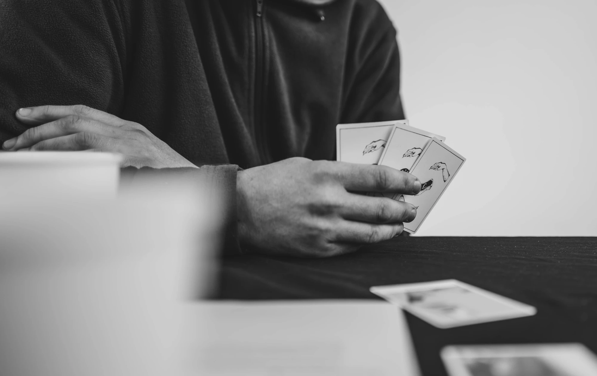 a close up of a card gamer at a table.